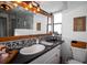 Stylish bathroom featuring a vanity, decorative lighting, and granite counters at 3717 Downer Ave, Sarasota, FL 34240