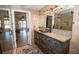 Well lit bathroom featuring tile floor, decorative sink and vanity, mirror, and a glass shower in the background at 3717 Downer Ave, Sarasota, FL 34240