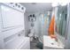Compact bathroom features tiled shower, modern vanity, and convenient laundry area at 3717 Downer Ave, Sarasota, FL 34240
