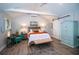 This stylish bedroom features wood floors, vaulted ceilings, a sliding barn door, and neutral tones at 3717 Downer Ave, Sarasota, FL 34240