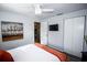 Bright bedroom featuring a closet, a mounted TV, and a comfortable bed at 3717 Downer Ave, Sarasota, FL 34240