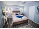 Comfortable bedroom with stylish decor, featuring natural light, wood-look flooring, and a plush rug at 3717 Downer Ave, Sarasota, FL 34240