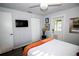Well-lit bedroom features a mounted TV, closet, and a door leading to the outside at 3717 Downer Ave, Sarasota, FL 34240