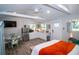 Open concept bedroom with a small kitchen, dining area, and neutral decor at 3717 Downer Ave, Sarasota, FL 34240