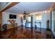 Bonus room featuring painted floors, unique decor, a ceiling fan and a window into the kitchen at 3717 Downer Ave, Sarasota, FL 34240