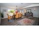 Bright dining room with rustic table, wicker chairs, wood floors and natural light at 3717 Downer Ave, Sarasota, FL 34240