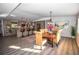 Open-concept dining and kitchen area with hardwood floors and modern appliances at 3717 Downer Ave, Sarasota, FL 34240