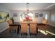 Bright dining room with natural light, stylish light fixture, and seating for six at 3717 Downer Ave, Sarasota, FL 34240