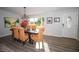 Dining room featuring wood floors, a modern light fixture, and seating for six at 3717 Downer Ave, Sarasota, FL 34240