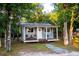 Charming cottage with a covered front porch and stone walkway at 3717 Downer Ave, Sarasota, FL 34240