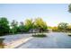 Charming guesthouse surrounded by mature trees and shrubs, complemented by a vast gravel parking area at 3717 Downer Ave, Sarasota, FL 34240