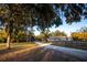 Long driveway leading to a light blue home with a welcoming porch, perfect for peaceful country living at 3717 Downer Ave, Sarasota, FL 34240