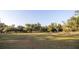 Open front lawn space offers a tranquil setting lined with mature trees and a charming wooden fence at 3717 Downer Ave, Sarasota, FL 34240