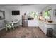 Bright kitchen features stainless appliances, white cabinets, and adjacent dining area at 3717 Downer Ave, Sarasota, FL 34240