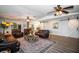 Open living room with leather sofas, ceiling fans, and view into the dining and kitchen areas at 3717 Downer Ave, Sarasota, FL 34240