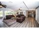 Bright living room with leather sofas, hardwood floors, and views into the kitchen at 3717 Downer Ave, Sarasota, FL 34240