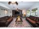 Spacious living room features two leather sofas, ceiling fans and a decorative area rug at 3717 Downer Ave, Sarasota, FL 34240