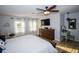 Inviting main bedroom with hardwood floors, a ceiling fan, and a wall-mounted television at 3717 Downer Ave, Sarasota, FL 34240
