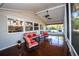 Enclosed patio with a ceiling fan, couches and seating, and a bright outdoor view of the property at 3717 Downer Ave, Sarasota, FL 34240