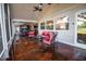 Covered patio with seating areas, offering serene views of the green backyard and mature shade trees on the property at 3717 Downer Ave, Sarasota, FL 34240