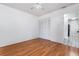 Bedroom with hardwood floors, closet and natural light and open doorway to the tile hallway at 3781 59Th W Ave # 3781, Bradenton, FL 34210