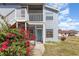Close up of a condo with screened entry, blue door, flowering bushes, and sidewalks at 3781 59Th W Ave # 3781, Bradenton, FL 34210