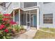 Close up of a condo with screened entry, blue door, flowering bushes, and sidewalks at 3781 59Th W Ave # 3781, Bradenton, FL 34210