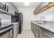 Updated kitchen boasts granite countertops, stainless steel appliances, and ample cabinet space at 3781 59Th W Ave # 3781, Bradenton, FL 34210