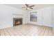 Bright living room featuring a classic fireplace, ceiling fan, and neutral tile flooring at 3781 59Th W Ave # 3781, Bradenton, FL 34210
