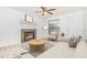 Staged living room with fireplace, tile floors, neutral paint, fan, and picture window at 3781 59Th W Ave # 3781, Bradenton, FL 34210