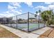 Community tennis court features dark fencing, palm trees, and a concrete perimeter at 3781 59Th W Ave # 3781, Bradenton, FL 34210