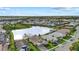 An aerial view captures a desirable lakeside community, complete with manicured lawns, and serene water features at 3808 Eastham Ln, Bradenton, FL 34211