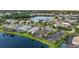 Aerial view showcasing a desirable residential community with lakes, manicured lawns, pools and lovely homes at 3808 Eastham Ln, Bradenton, FL 34211