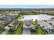 An aerial view features an attractive home with a lakeside location in a desirable community, with manicured lawns and landscaping at 3808 Eastham Ln, Bradenton, FL 34211
