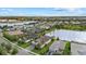Aerial view showcasing a lakeside residential community with well-maintained lawns, scenic water views, and beautiful homes at 3808 Eastham Ln, Bradenton, FL 34211