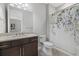 Charming bathroom featuring a granite countertop vanity and a floral shower curtain at 3808 Eastham Ln, Bradenton, FL 34211