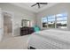 Serene bedroom view with dresser, outdoor view, and access to the en-suite bathroom at 3808 Eastham Ln, Bradenton, FL 34211