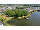 Scenic aerial view of the community park featuring a lake, a pier, and a playground, surrounded by lush greenery at 3808 Eastham Ln, Bradenton, FL 34211