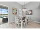 Dining room with modern light fixture and view of lanai and water at 3808 Eastham Ln, Bradenton, FL 34211