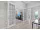 Inviting entryway featuring wood-look tile floors and stylish french doors leading to the living room at 3808 Eastham Ln, Bradenton, FL 34211