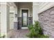Inviting front entrance featuring a decorative glass door, stone accents, and a paved walkway at 3808 Eastham Ln, Bradenton, FL 34211