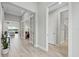 Bright hallway with wood-look tile, white trim, and an inviting view into the dining and living spaces at 3808 Eastham Ln, Bradenton, FL 34211