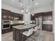 Modern kitchen with a large island, stainless steel appliances, and dark wood cabinets at 3808 Eastham Ln, Bradenton, FL 34211
