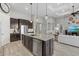 Open-concept kitchen island and stainless steel appliances offer modern living and entertaining at 3808 Eastham Ln, Bradenton, FL 34211