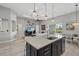 Open kitchen with island and stainless steel appliances, adjoining living area and patio access at 3808 Eastham Ln, Bradenton, FL 34211