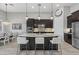 Bright, open kitchen with an island, pendant lights and stainless steel appliances at 3808 Eastham Ln, Bradenton, FL 34211