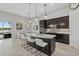 Spacious kitchen with dark cabinetry, granite countertops, pendant lighting and dining area with water view at 3808 Eastham Ln, Bradenton, FL 34211
