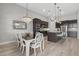 Open kitchen and dining area with modern fixtures and wooden flooring at 3808 Eastham Ln, Bradenton, FL 34211