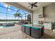 Beautiful outdoor lanai with a summer kitchen, a lake view, and comfortable seating at 3808 Eastham Ln, Bradenton, FL 34211