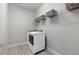 Well-lit laundry area with new machines, ample storage shelves, and clean, tiled floors at 3808 Eastham Ln, Bradenton, FL 34211